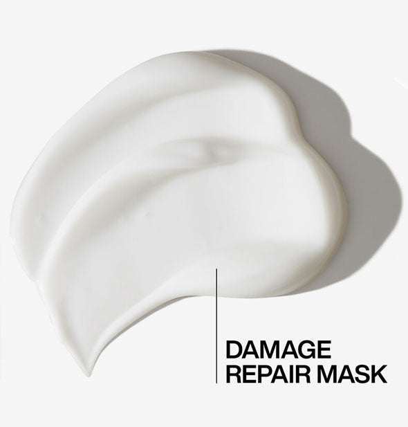 Closeup of a glob of Redken Acidic Bonding Concentrate 5-Min Liquid Mask labeled, "Damage repair mask"