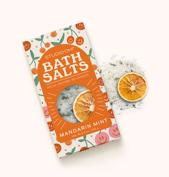 Studio Oh! Mandarin Mint Bath Salts pack with sample salts and dried orange garnish dispensed at right of packaging