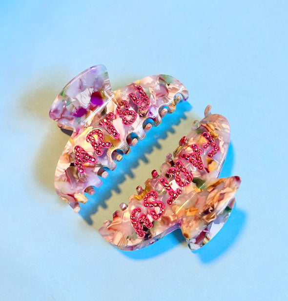 Colorful quartz-effect hair clips on blue backdrop say, "Artsy" and "Fartsy" in pink with rhinestone accents
