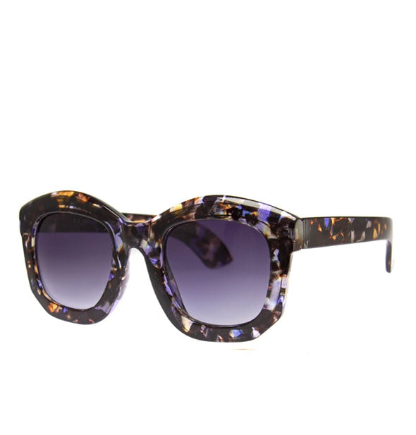 Pair of rounded sunglasses in a brown and blue flecked tortoise finish with blueish-gray gradient lenses
