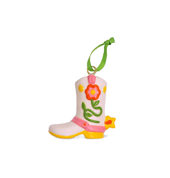 White Western-style boot ornament with colorful floral design, spur, and green ribbon hanging loop tied to the top