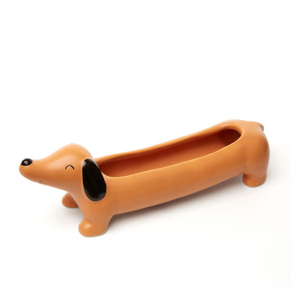 Elongated Dachshund dog planter with black nose, eye, and ear details