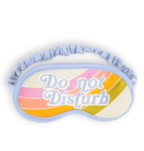 Sleep mask with light blue piping and ruched elastic band says, "Do not disturb in white and blue lettering overtop colorful stripes on a white background