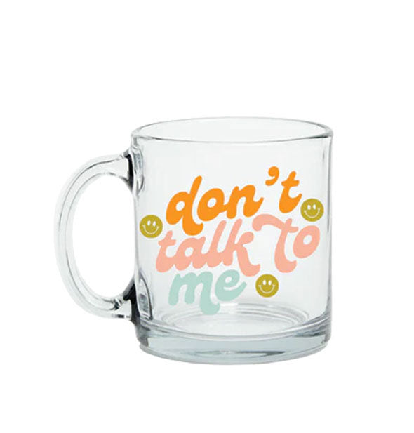 Clear glass mu says, "Don't talk to me" in orange, pink, and blue script lettering accented by three greenish-yellow smiley faces