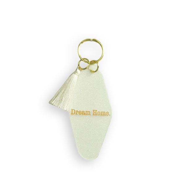 White tab keychain on gold hardware with white tassel says, "Dream Home" in gold lettering