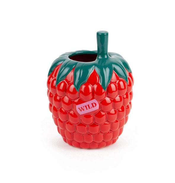 Red and green ceramic raspberry flower vase with small pink "Wild" sticker on the side and a protruding stem at the top