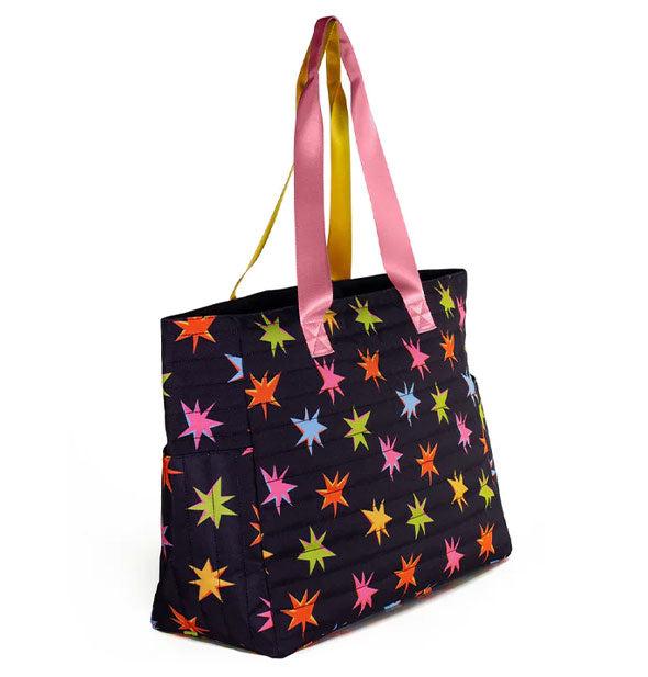 Black shoulder bag with two-tone pink and yellow straps and all-over colorful starburst print