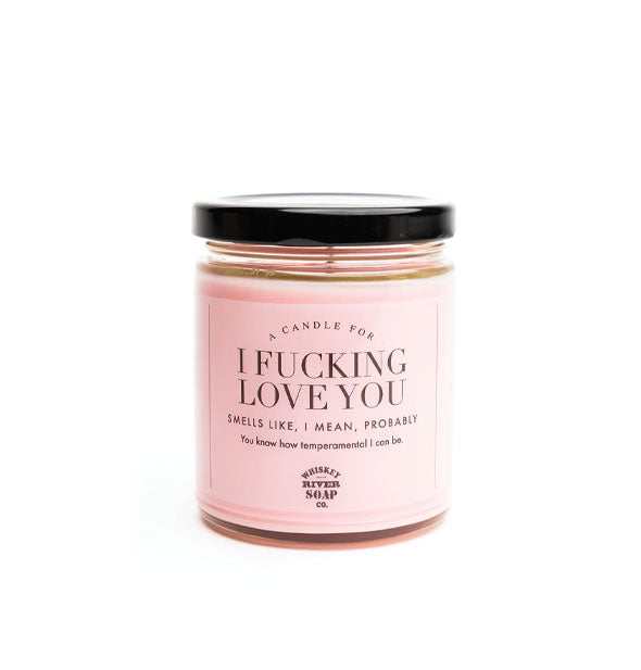 A Candle for I Fucking Love You (Smells Like, I Mean, Probably) by Whiskey River Soap Co. in a clear glass vessel with black lid and pink label