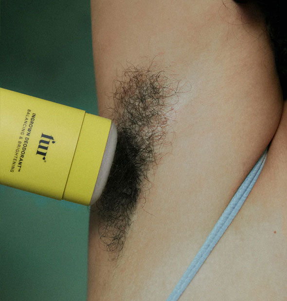 Closeup of a Fur Ingrown Deodorant stick being applied to a model's underarm