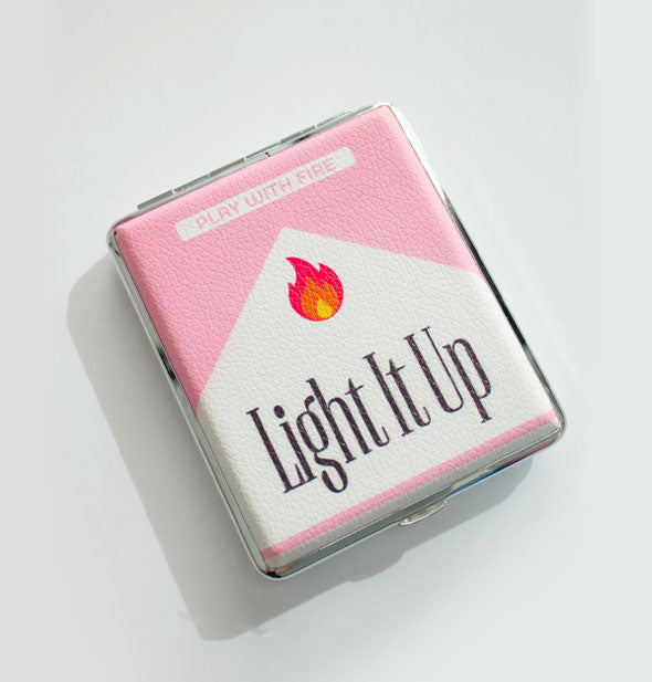 Rectangular pink and white csae with silver rim features a flame graphic above the words, "Light It Up" in Marlboro-style lettering; "Play with fire" is printed in the pink space above