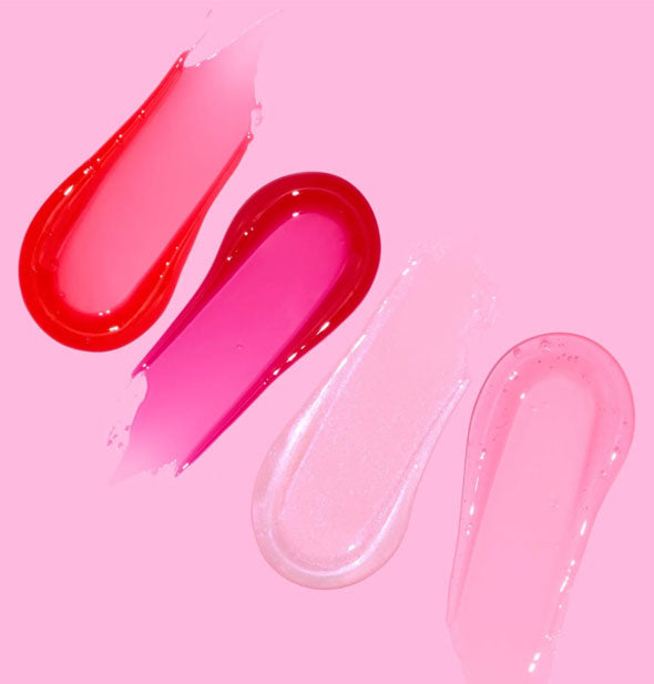 Sample swabbed applications of each shade of Plump & Pout lip gloss in orangey-red, fuchsia, clear, and light pink