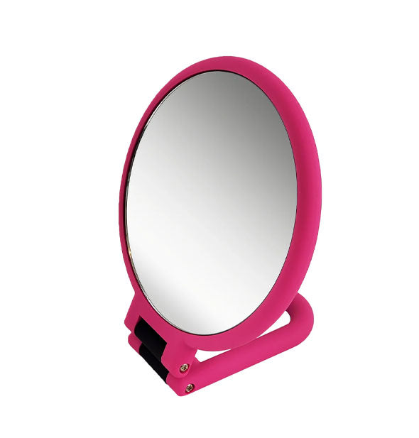 Round pink hand mirror with folded-under handle base