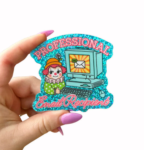 Model's hand holds a glittery blue sticker with illustration of a clown sitting at a desktop computer around which pink lettering says, "Professional Email Recipient"