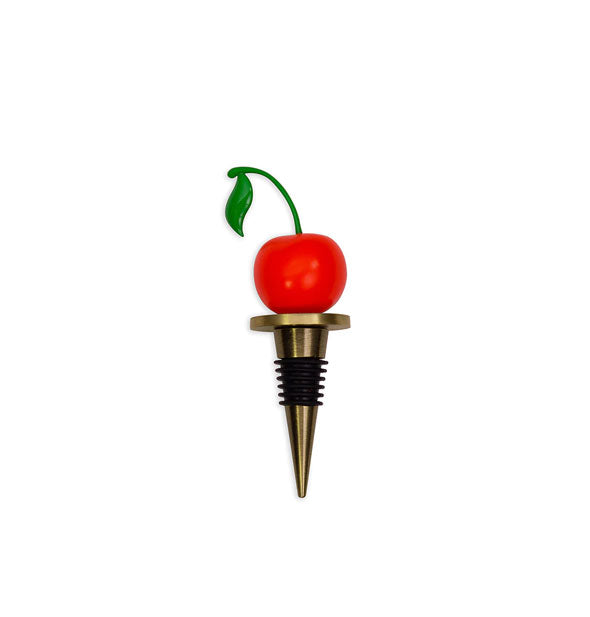 Brassy metallic bottle stopper with black rubber ridges on its conical base and a red cherry with green stem on top