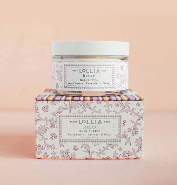Jar and box of Lollia Relax Body Butter feature purple floral patterning with a purple, white, and yellow striped box lid