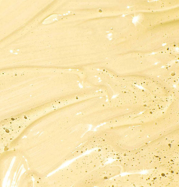 Closeup sample of Mizani 25 Miracle Nourishing Oil shows product consistency