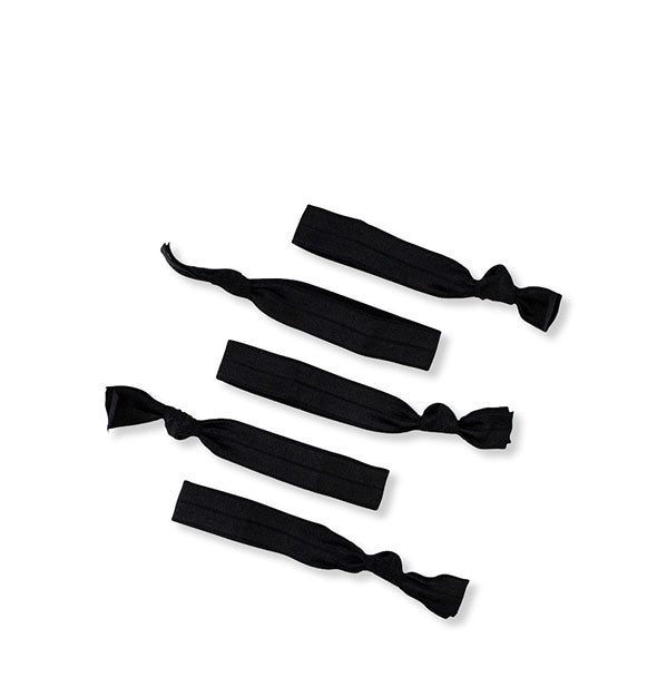 Five tied black fabric hair elastics