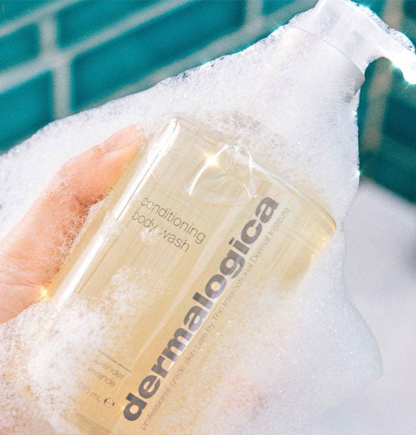 A bottle of Dermalogica Conditioning Body Wash covered in suds