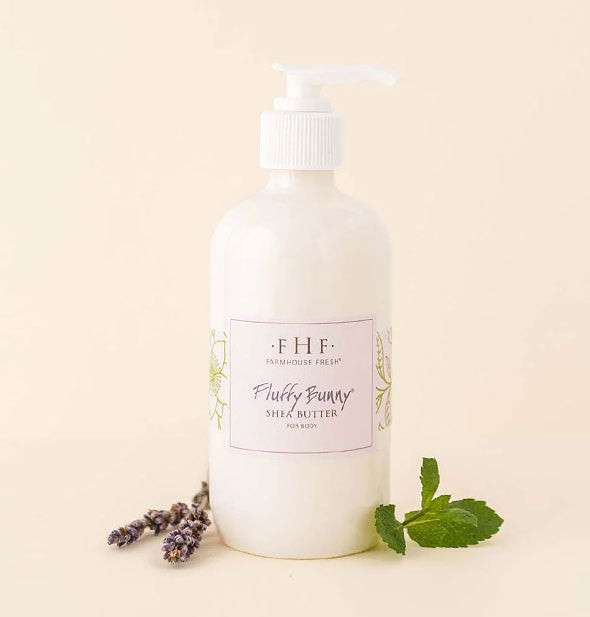 Bottle of FarmHouse Fresh Fluffy Bunny Shea Butter for Body with sprigs of mint and lavender