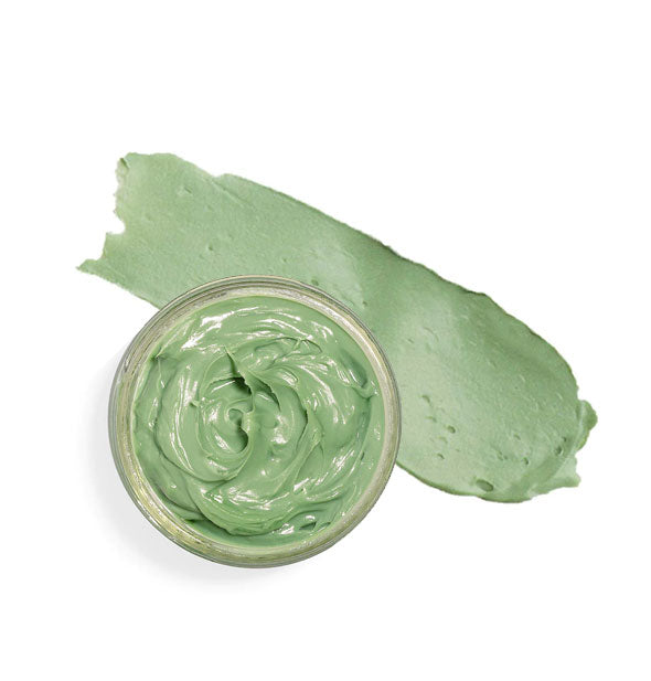Top view of green face mask pot with sample product smear beside it