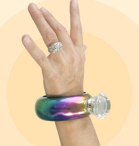 Model wears a Metallic Rainbow Bracelet Flask on wrist