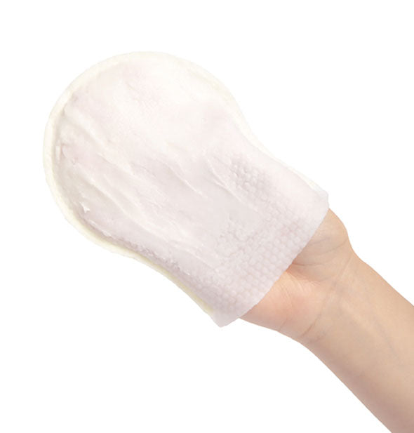 Model's hand wears a body cleansing mitt