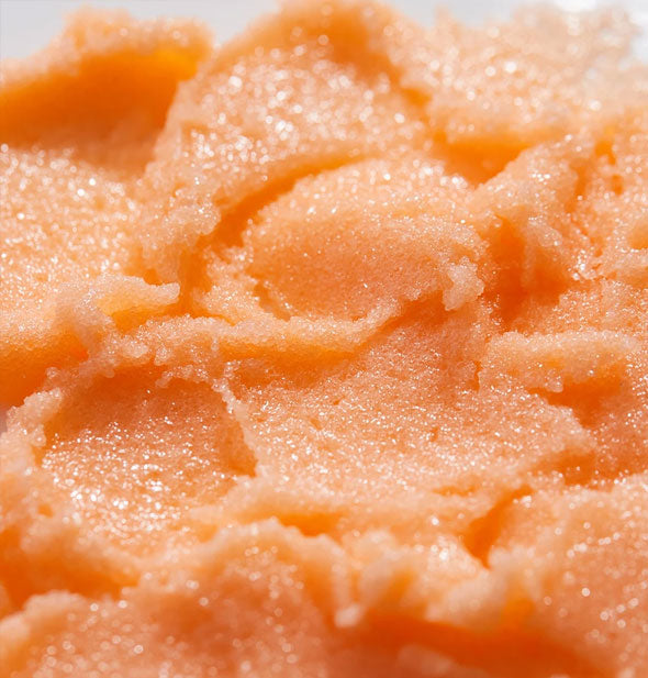 Closeup of peach-colored sugar scrub
