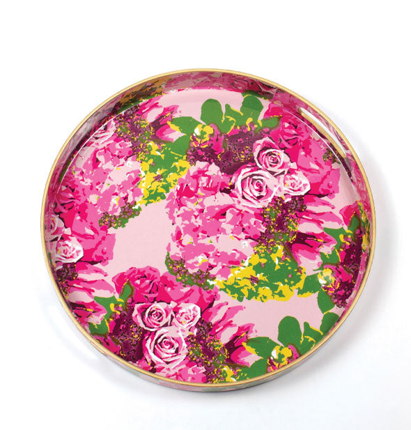 Round serving tray with gold rim features an all-over pattern of pink and yellow florals with gold leaves