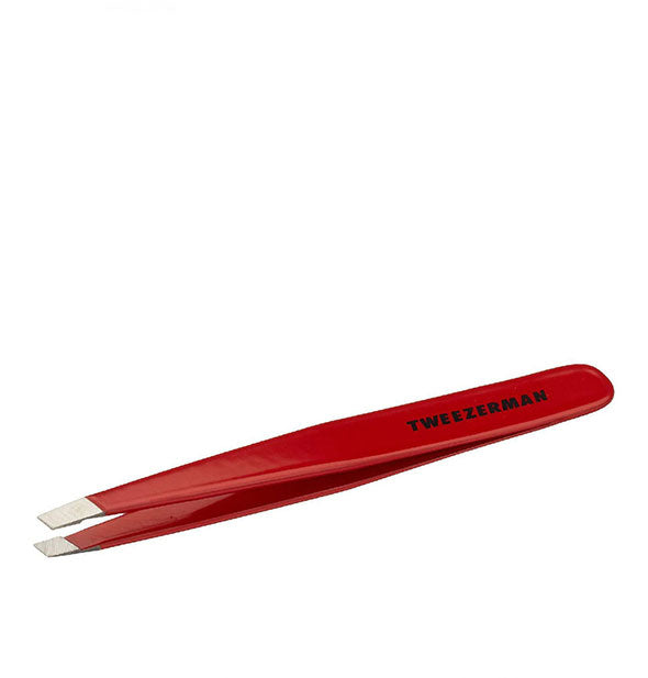 Red tweezer with black Tweezerman logo on the handle and slanted stainless steel tips