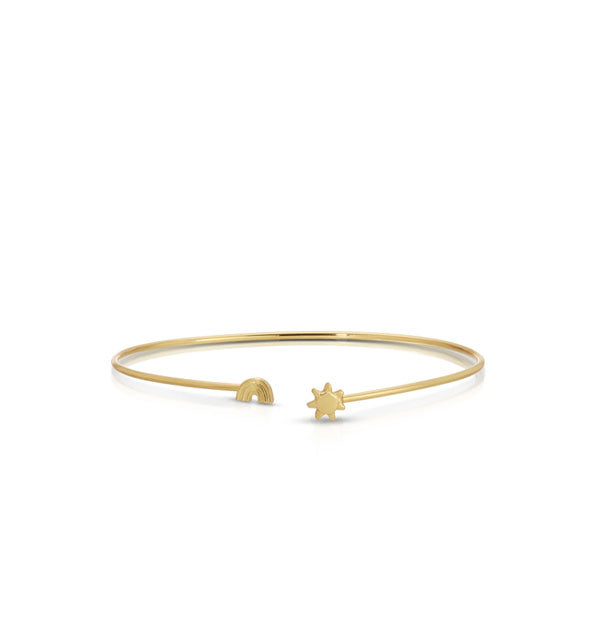 Thin gold cuff-style bracelet with rainbow and sun charms on each open end