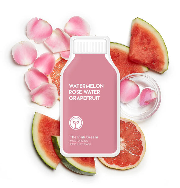 Pink bottle-shaped Pink Dream sheet mask pack rests on slices of watermelon and grapefruit and pink rose petals