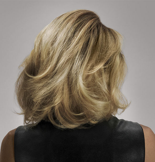 Shoulder-length blonde hair is styled with Oribe Thick Dry Finishing Spray