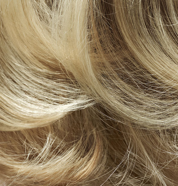 Closeup of hair that is styled with Oribe Thick Dry Finishing Spray