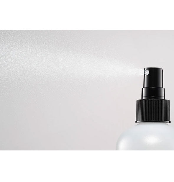 A fine mist is dispensed from a bottle of Bumble and bumble Thickening Spray