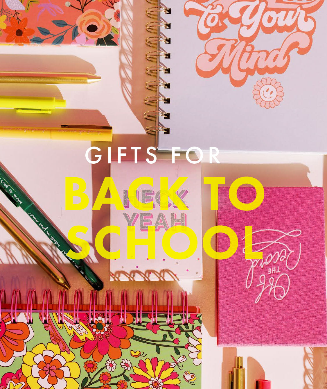 The words, "Gifts for back to school" in white and yellow lettering appear over an assortment of colorful notebooks and pens