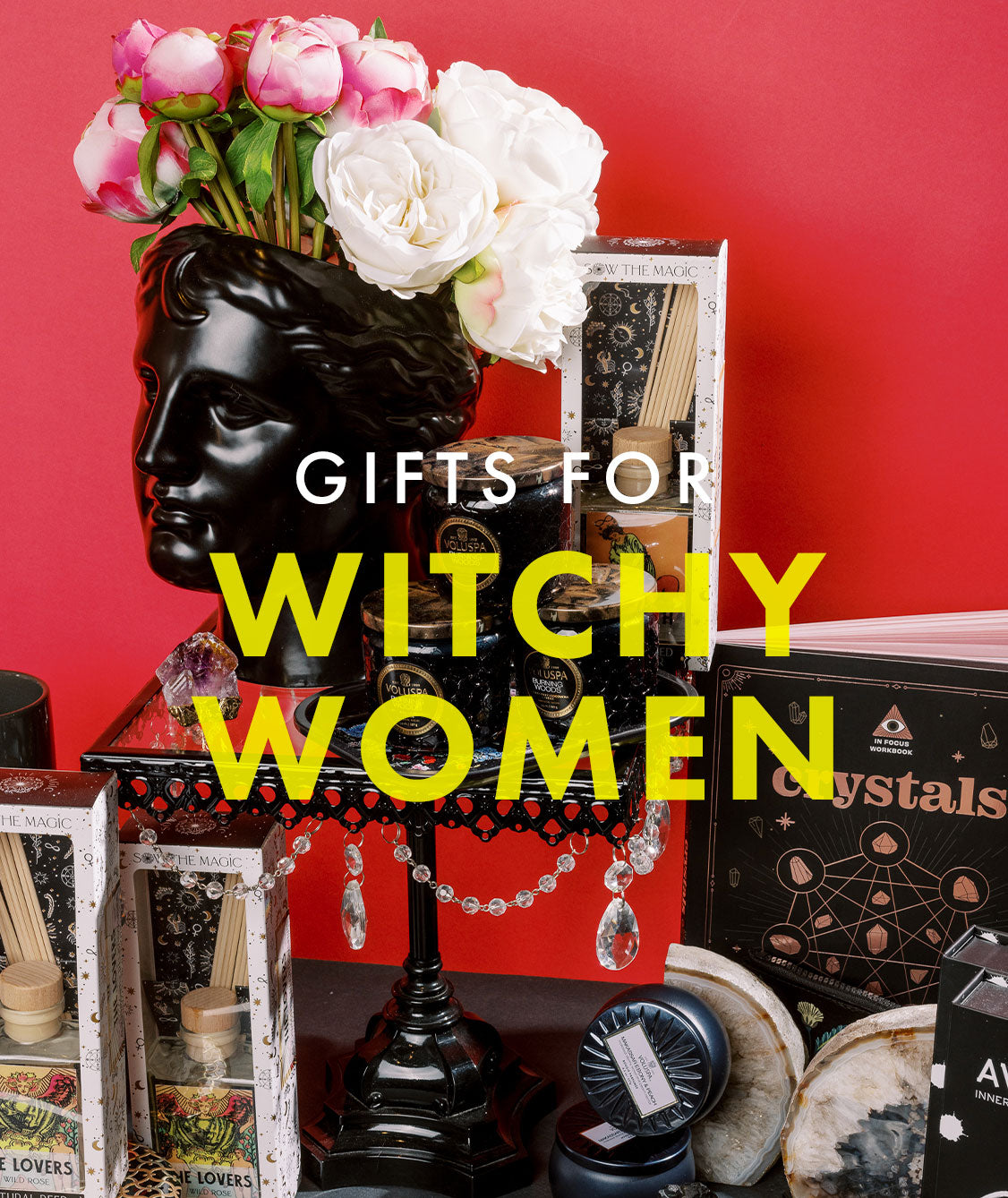 Gift items including a black sculptural face vase holding pink and white flowers are staged against a red background with the words, "Gifts for Witchy Women" overtop in white and yellow minimalist lettering