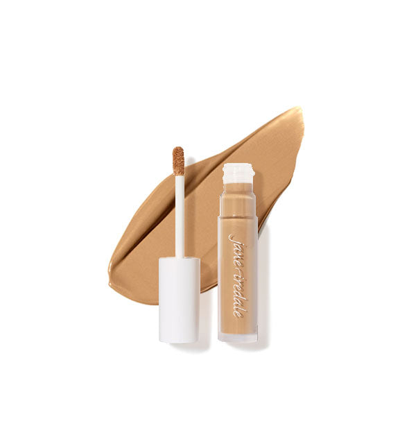 Clear tube of Jane Iredale concealer with doe foot applicator cap removed rests on top of an enlarged sample product application in shade 10N