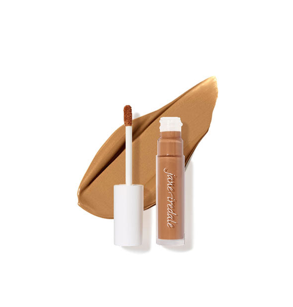 Clear tube of Jane Iredale concealer with doe foot applicator cap removed rests on top of an enlarged sample product application in shade 11N
