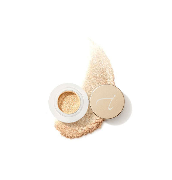 Opened pot of Jane Iredale 24-Karat Gold Dust with swiped sample product application underneath