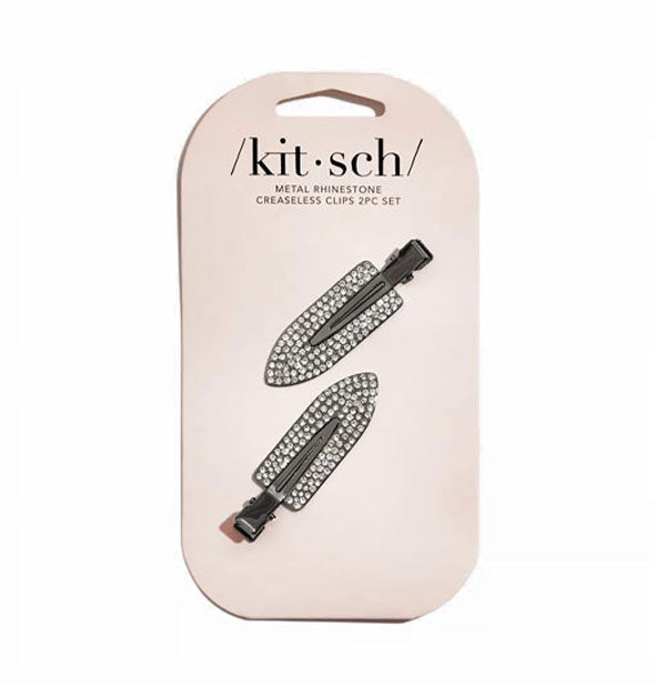 Two dark metal rhinestone-encrusted creaseless hair clips are attached to a light-colored Kitsch product card