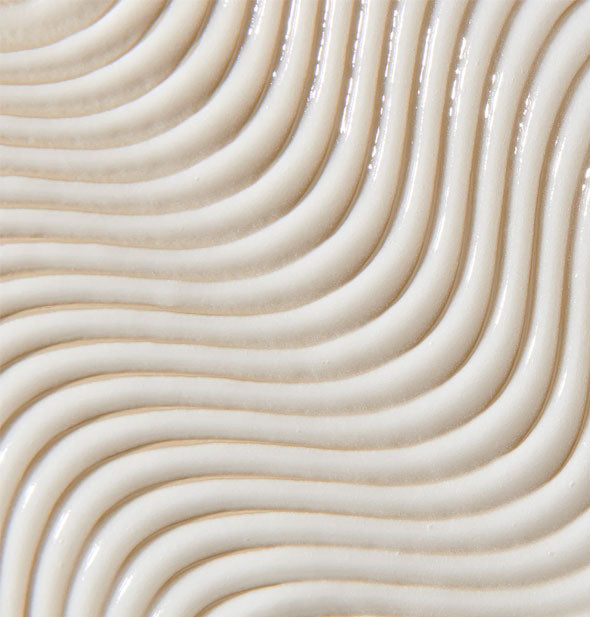 Closeup of Unite 7SECONDS BlowOut Crème has curved lines raked through it