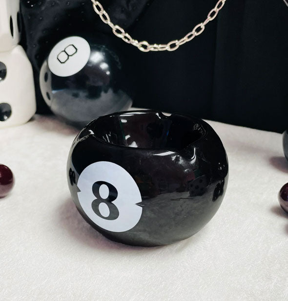 Black and white 8 ball ashtray features a hollowed-out center and three deep grooves along its rim