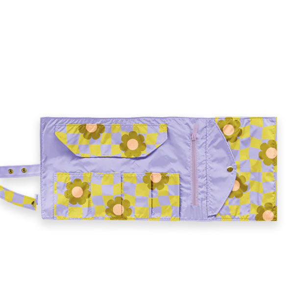 Inside of the Cool Funky Daisy Tootsie Roll reveals slip pockets with protective flap for brush storage, zipper pocket, and snap button closure pocket