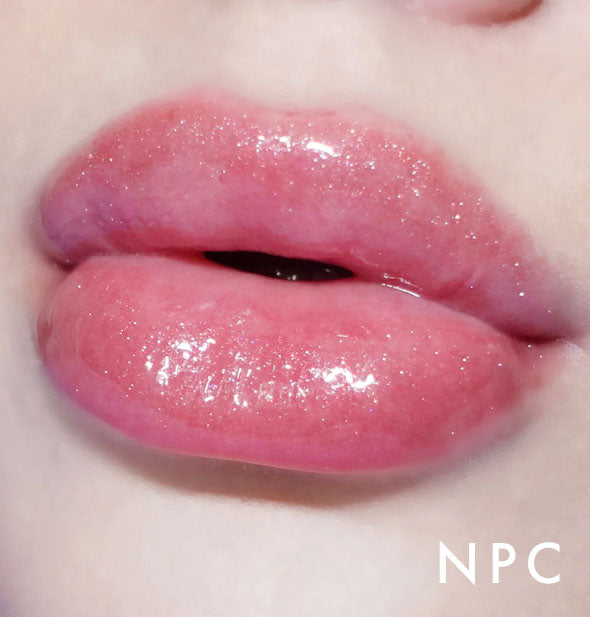 Closeup of model's lips wearing Kara Beauty Level Up! Nourishing Lip Gloss in NPC pink with light shimmer