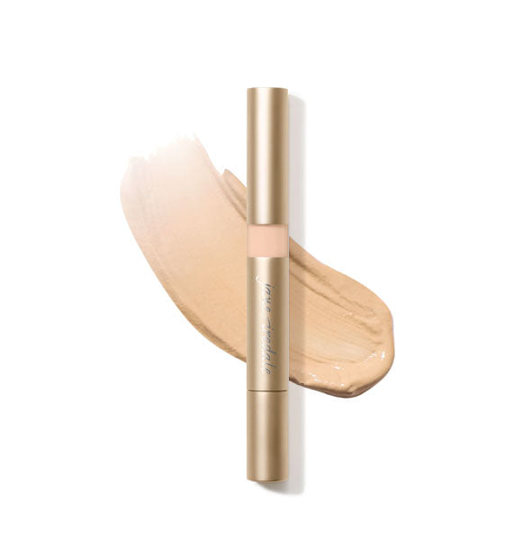 Gold tube of Jane Iredale Active Light Concealer with sample product application underneath in the shade No. 3 - Light Peach