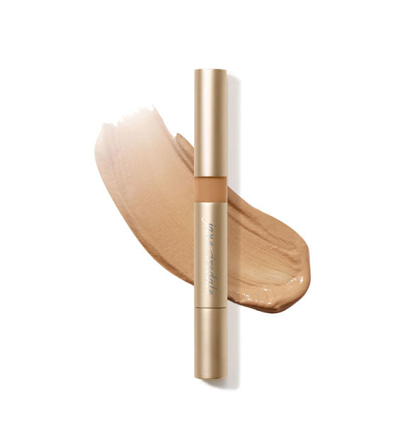 Gold tube of Jane Iredale Active Light Concealer with sample product application underneath in the shade No. 6 - Medium Dark Peachy Brown