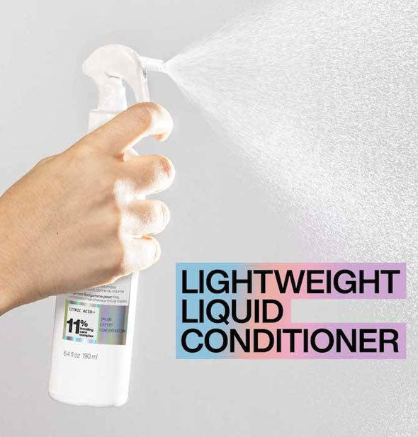 Model's hand dispenses a fine mist from a bottle of Redken Acidic Bonding Concentrate Lightweight Liquid Conditioner