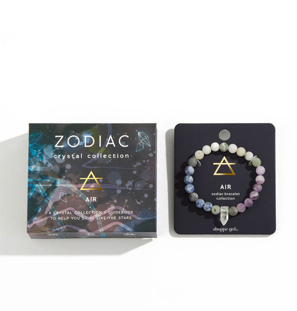 Zodiac Crystal Collection Air bead bracelet with blue, gray, and purple color scheme on backer card next to box