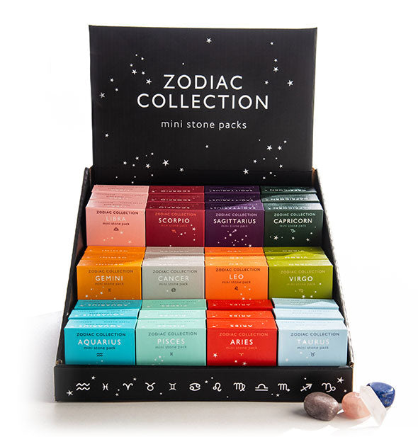 A display for Zodiac Collection Mini Stone Packs is stocked with boxes for each of the 12 zodiac signs.