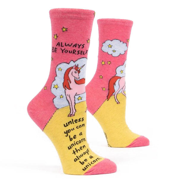 Pair of pink and yellow crew socks with unicorn, cloud, and star designs say, "Always be yourself. Unless you can be a unicorn, then always be a unicorn" in black lettering